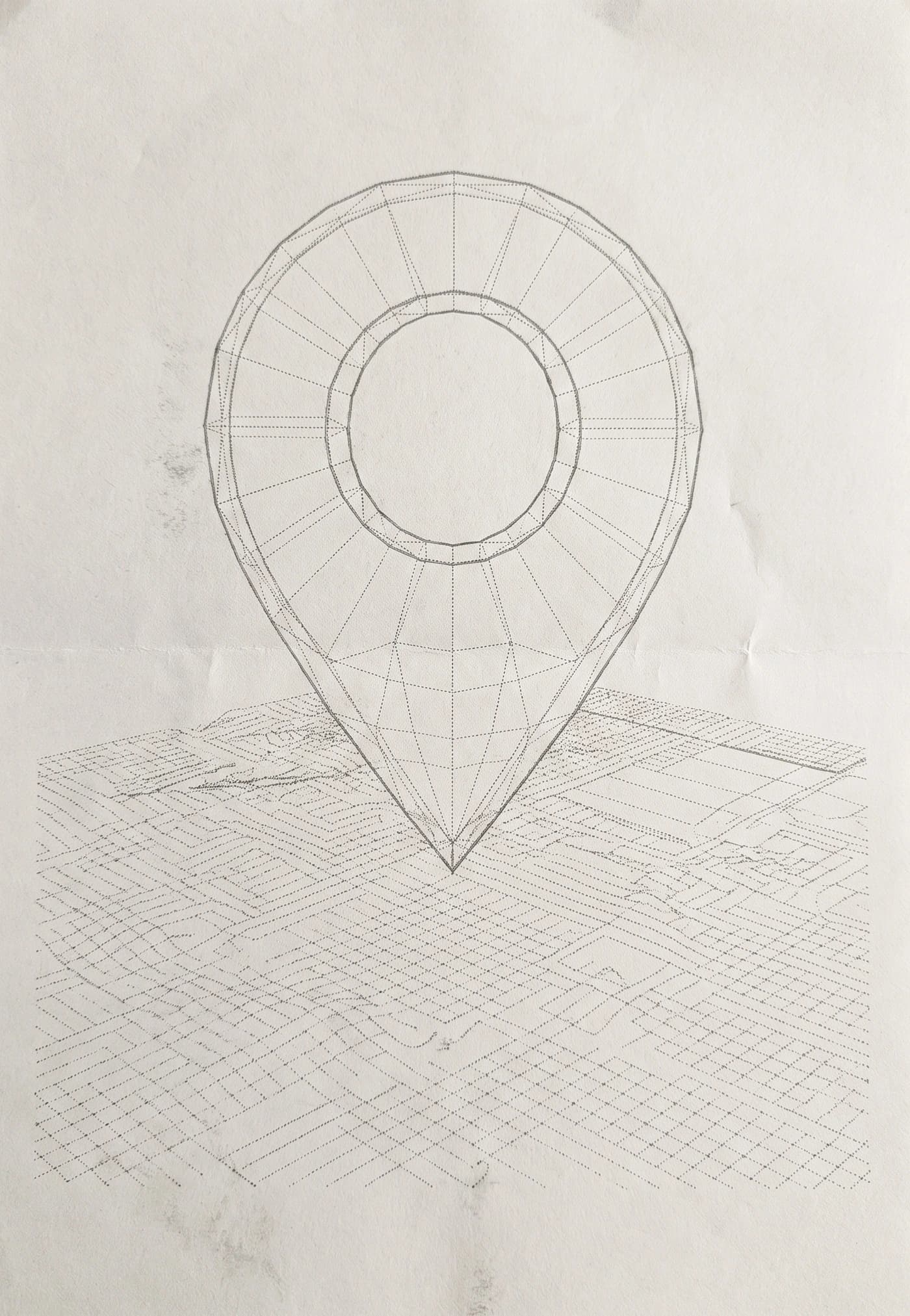 Sketch of a map pin over a grid on cream paper