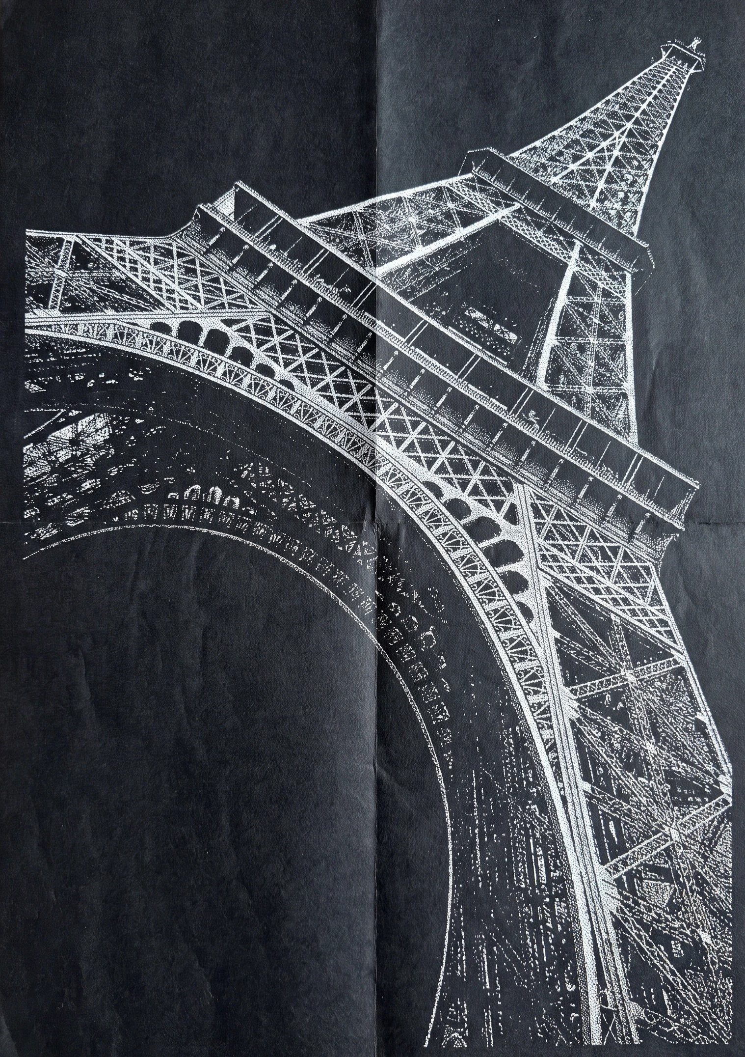 The Eiffel Tower seen from below, in white lines on black paper